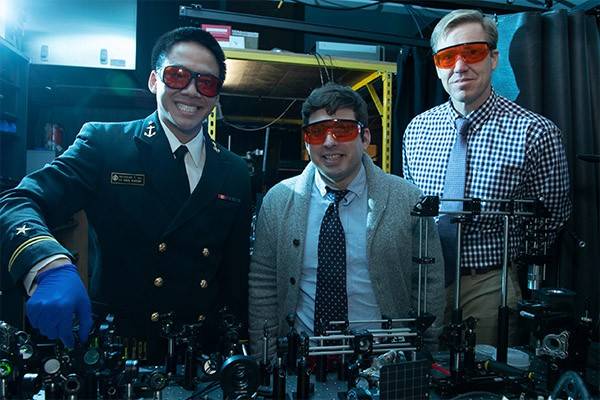 Ronald Warzoha stands with two of his U.S. Naval Academy students in a lab.