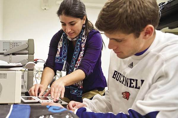 Amal Kalaban, assistant professor at Bucknell University, works with a student in the lab.