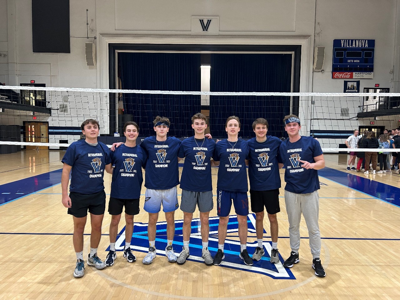Male students posing for volleyball champion photo