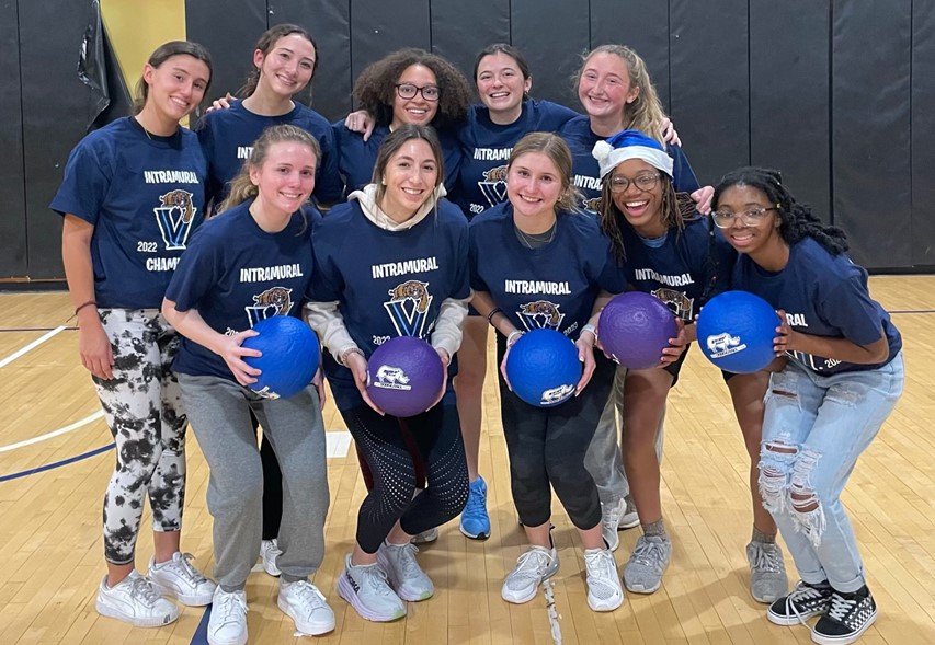 Female students posing for dodgeball champion photo