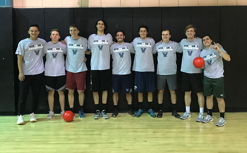 Male students posing for dodgeball champion photo