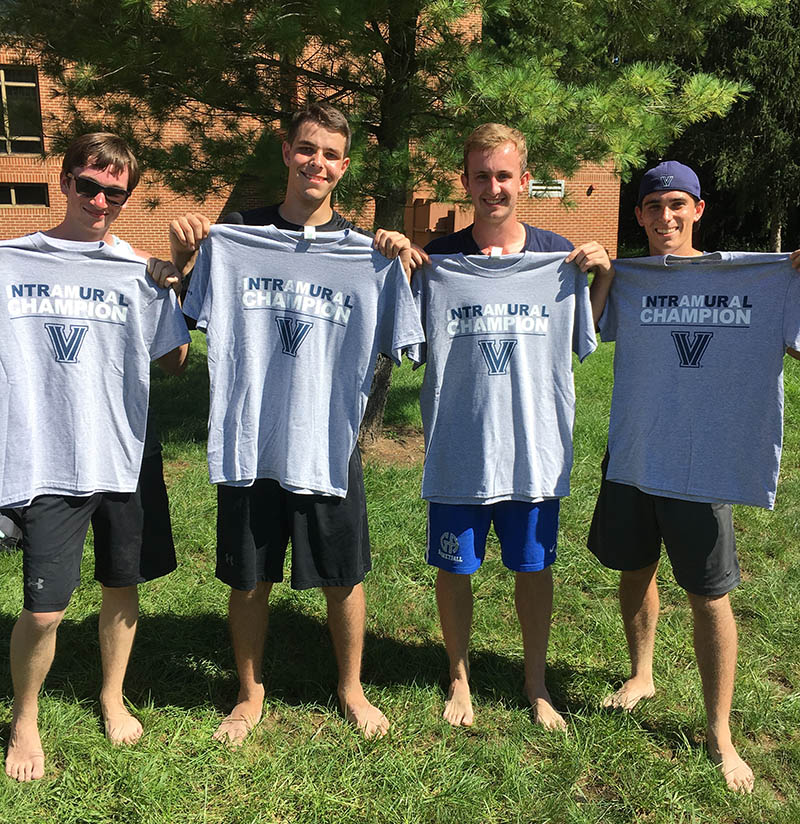 Male students posing for sand volleyball photo