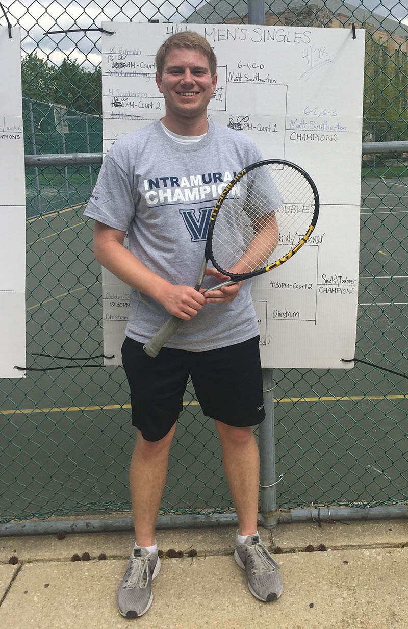 Male student posing for singles tennis champion photo