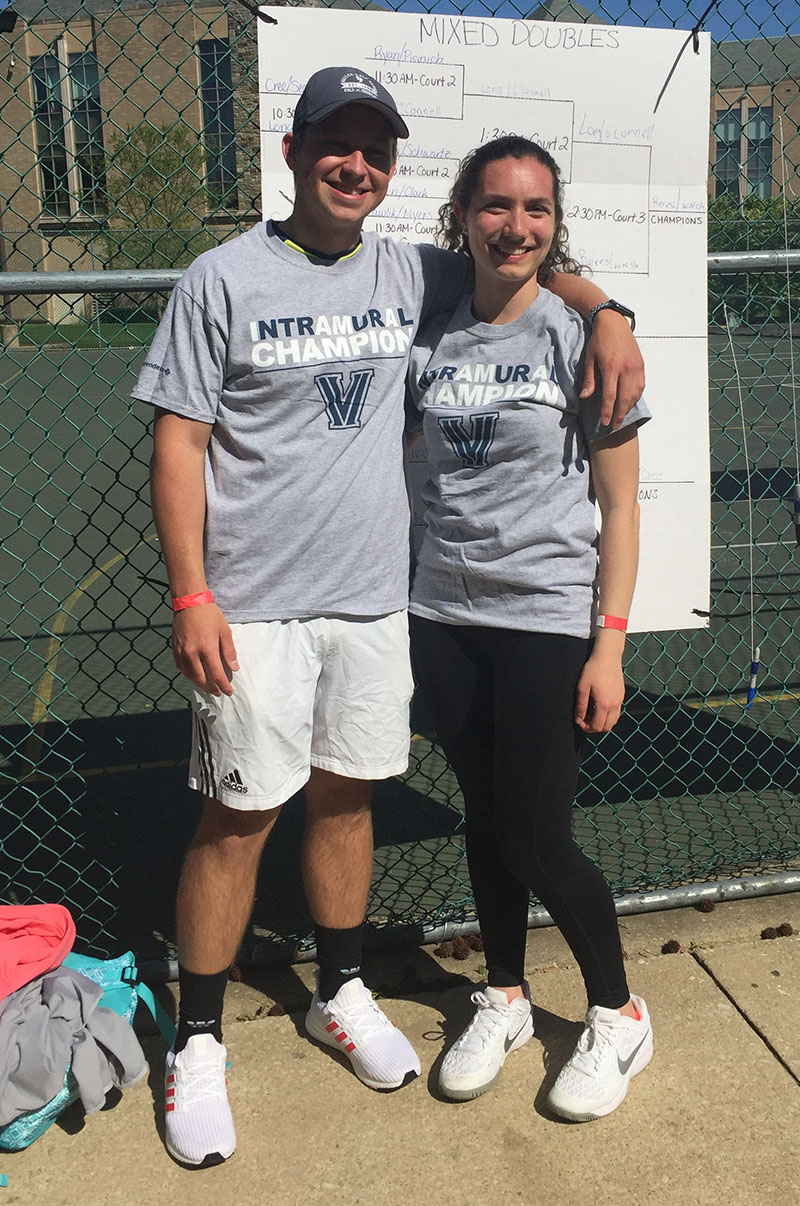Two sttudents posing for doubles tennis champion photo