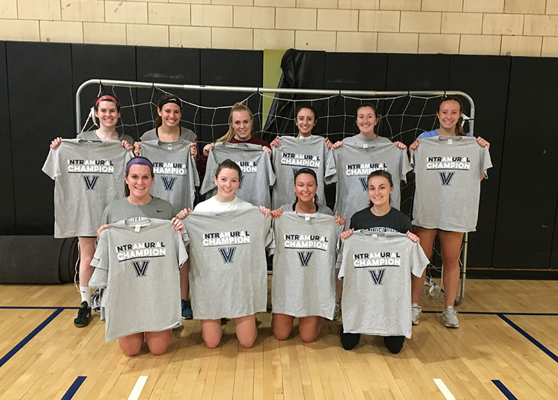Female students posing for indoor soccer champion photo