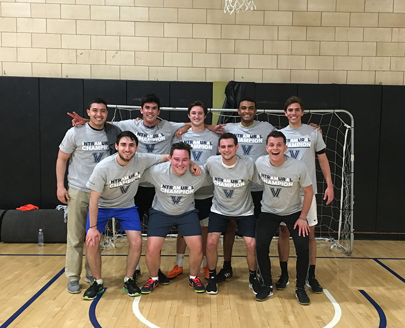 Male students posing for indoor soccer champion photo