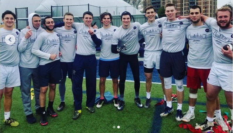 Male students posing for flag football champion photo