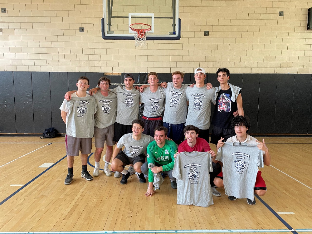 Male students posing for indoor soccer champion photo