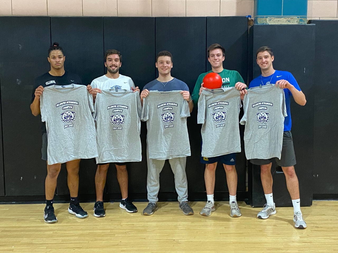 Male students posing for dodgeball champion photo