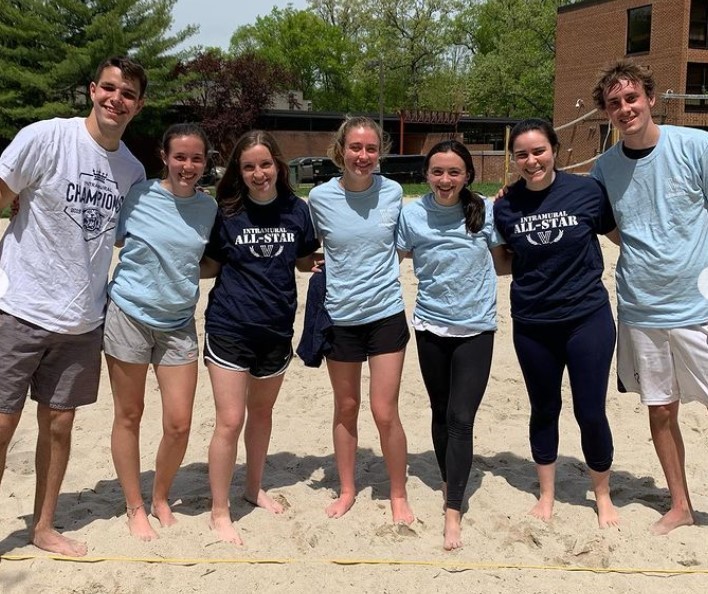 Students posing for sand volleyball champion photo