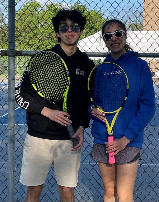 Two students posing for doubles tennis champs photo
